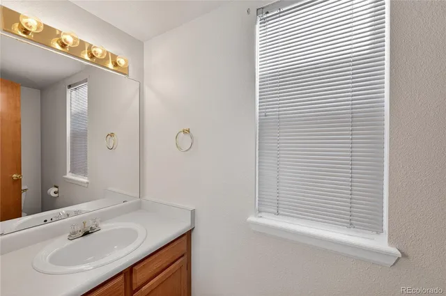a spacious bedroom with a bed and a chandelier