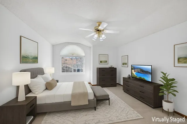 an empty room with chandelier fan and windows