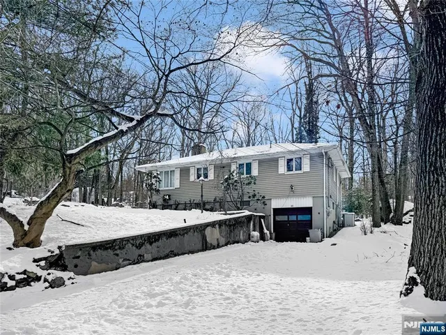 a wooden bench sitting in front of house