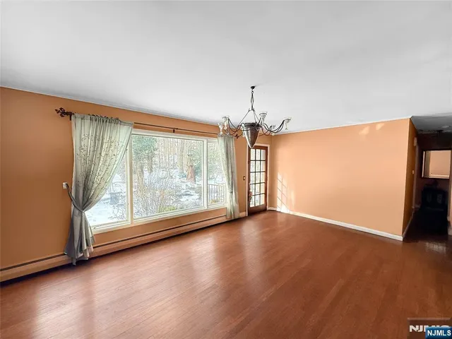 a large kitchen with stainless steel appliances granite countertop a refrigerator and a stove top oven