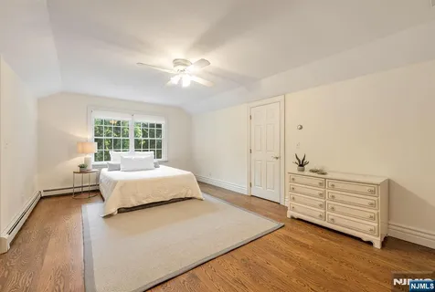 a spacious bedroom with a bed and a window