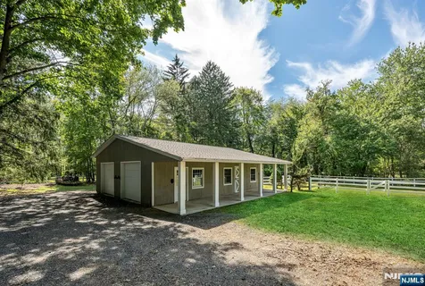 a view of a house with yard and sitting area