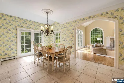 a view of a dining room with furniture and chandelier