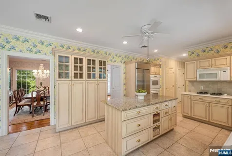 a kitchen with granite countertop a sink and cabinets
