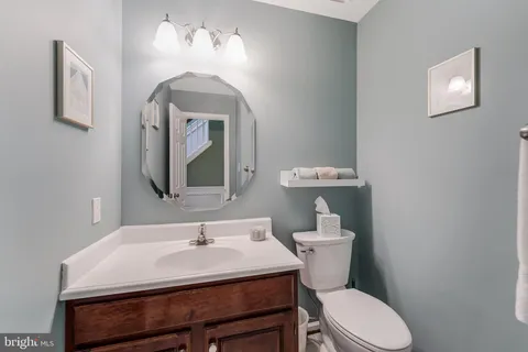 a spacious bathroom with a double vanity sink a mirror and a bathtub