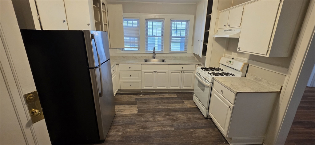 a kitchen with a refrigerator stove and sink