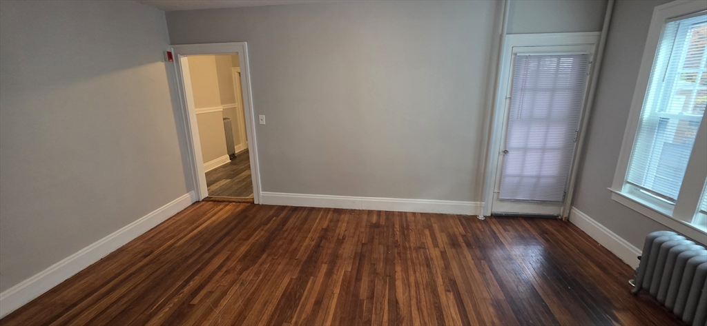 33 Harbor Street, Unit 1R Salem, MA 01970 - Photo 5 of 9 an empty room with wooden floor and windows