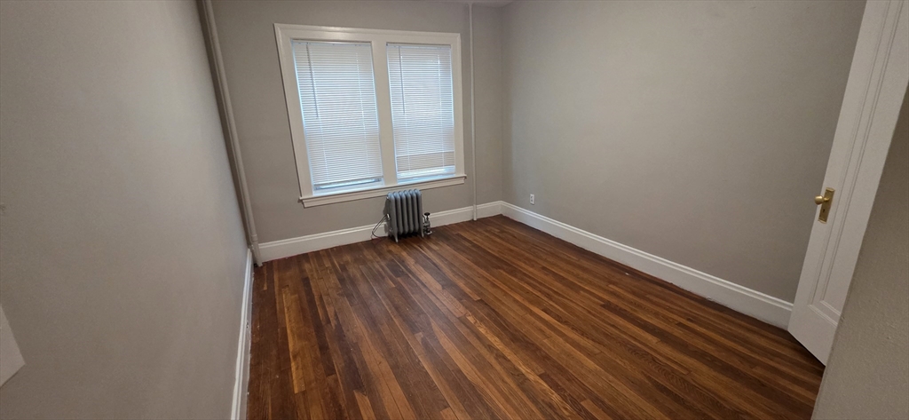 33 Harbor Street, Unit 1R Salem, MA 01970 - Photo 6 of 9 a view of an empty room with wooden floor and a window