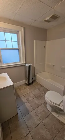 a bathroom with a toilet and a bathtub