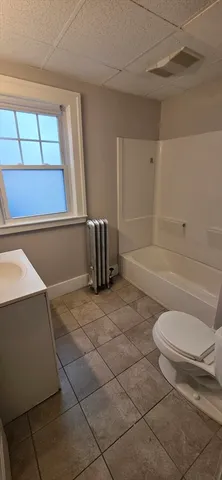 a bathroom with a toilet and a bathtub