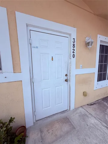 a kitchen with a stove a sink and a refrigerator
