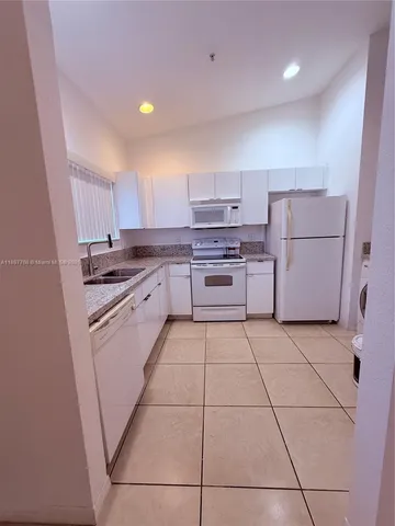 a kitchen with a stove top oven and cabinets