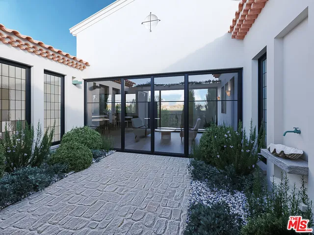 a porch with potted plants and floor to ceiling window