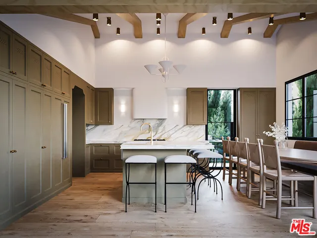 a dining hall with stainless steel appliances kitchen island granite countertop a table chairs and a wooden floor