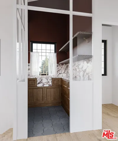 a kitchen with stainless steel appliances kitchen island granite countertop a refrigerator and a sink