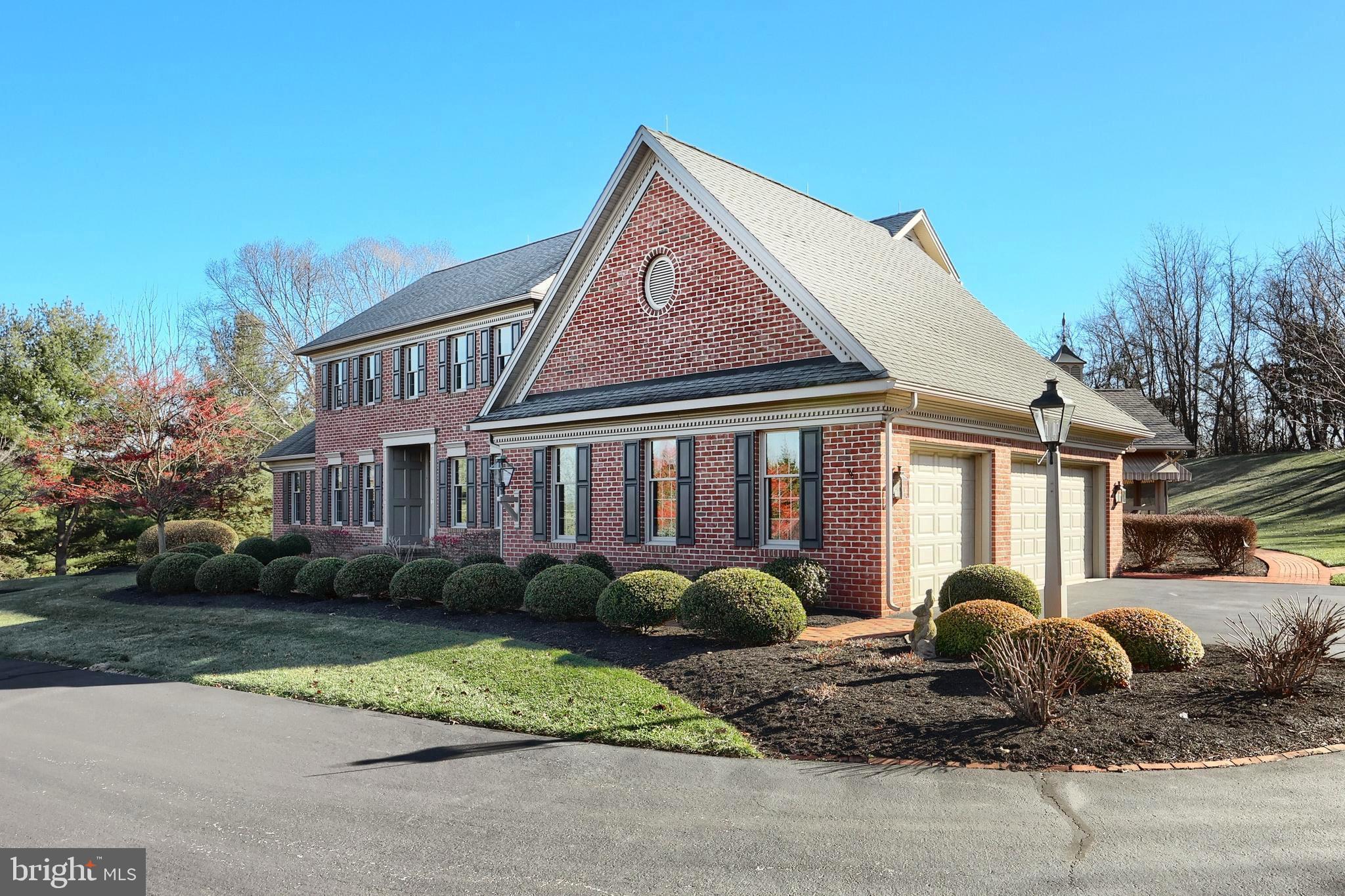 245 Orchard Drive Hanover, PA 17331 - Photo 7 of 78 a front view of a house with a garden and plants