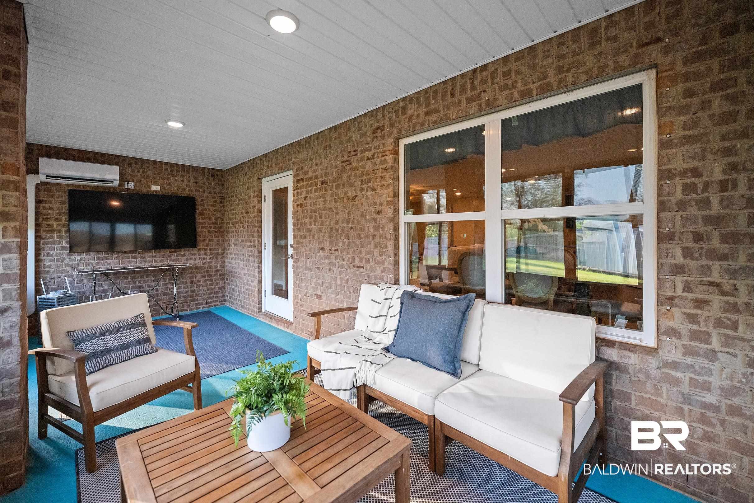 8294 Irwin Loop Daphne, AL 36526 - Photo 24 of 29 Covered brick patio featuring recessed lighting, a ceiling-mounted mini-split unit, and a large window