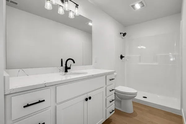 a view of bathroom with a sink mirror and toilet