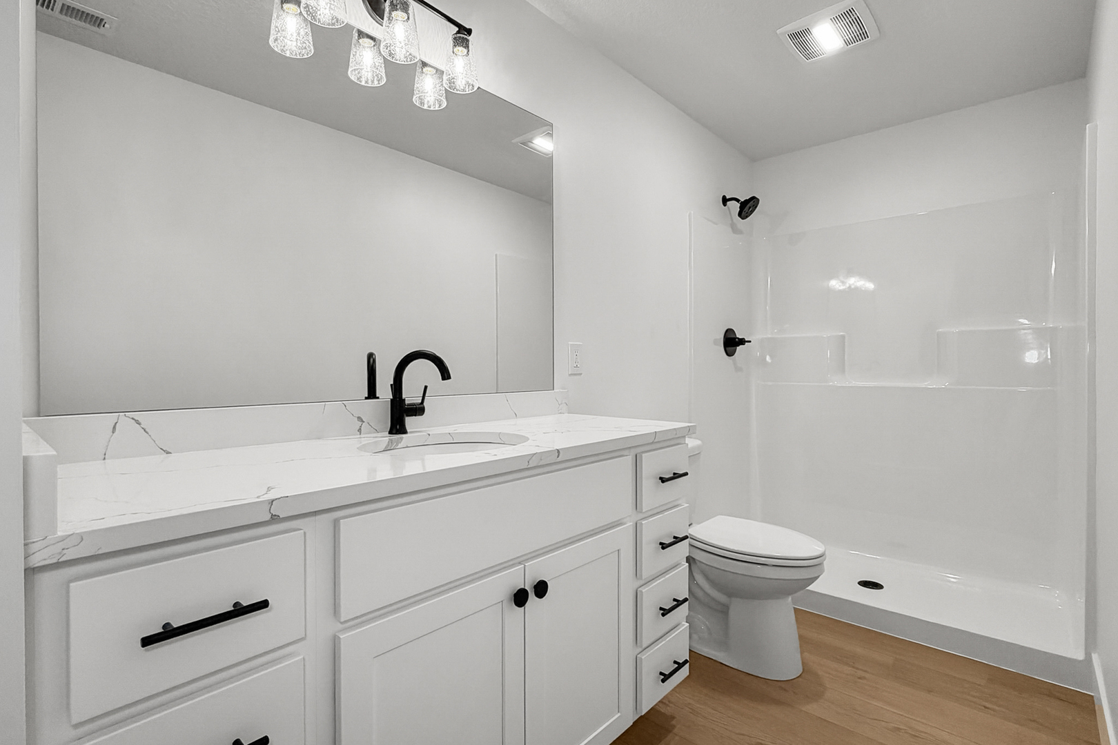 606 Kevin Road Blue Grass, IA 52726 - Photo 13 of 33 a view of bathroom with a sink mirror and toilet