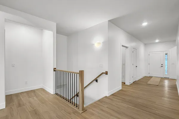 a view of a hallway with wooden floor