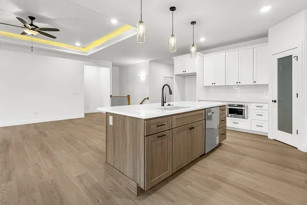 a kitchen with a sink cabinets and wooden floor