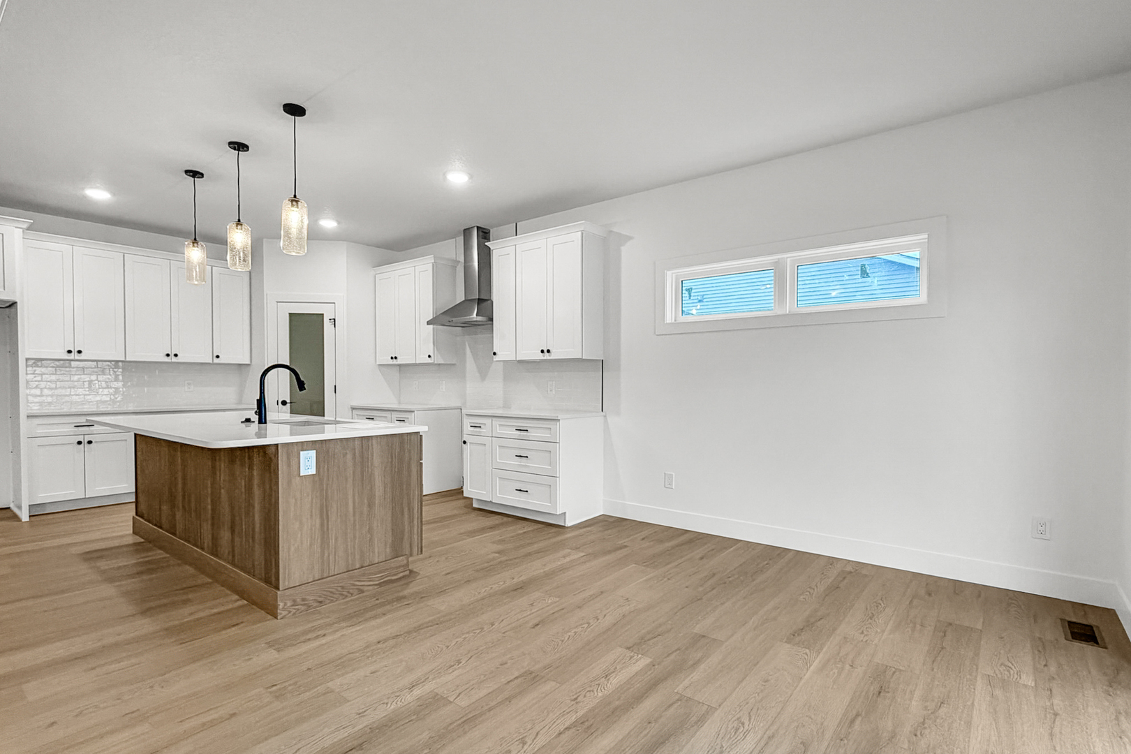 606 Kevin Road Blue Grass, IA 52726 - Photo 27 of 33 a large white kitchen with wooden floor