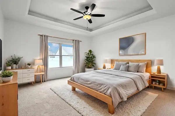 a spacious bedroom with a bed and a chandelier