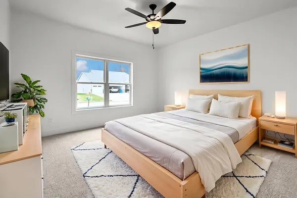 a bedroom with a bed and a window