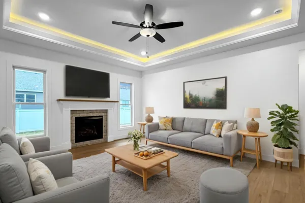 a living room with furniture a fireplace and a flat screen tv