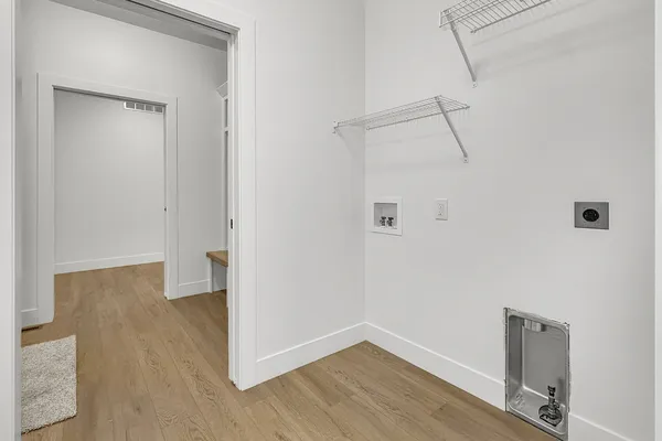 a view of a room with wooden floor