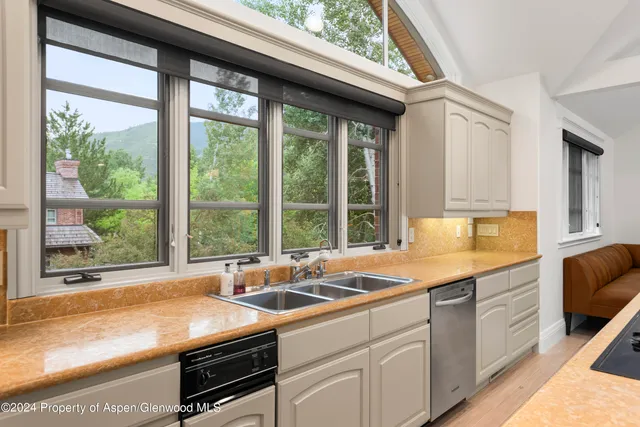 a kitchen with a large window and a sink