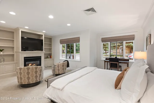 a bedroom with bed and a flat screen tv