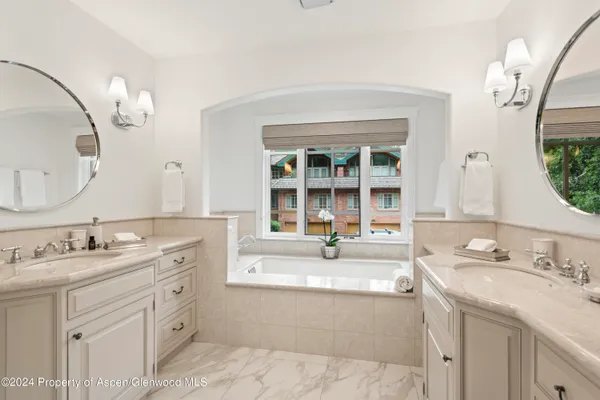 a spacious bathroom with a sink double vanity and a mirror