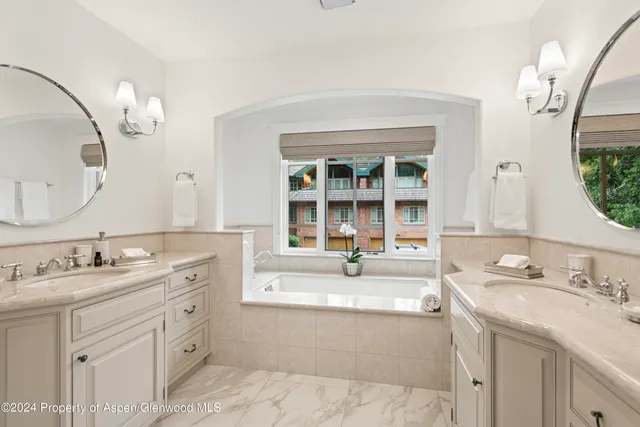 a spacious bathroom with a sink double vanity and a mirror