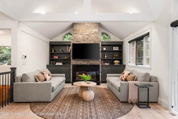 a living room with furniture and a fireplace