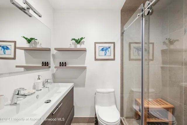 a bathroom with a sink toilet and shower