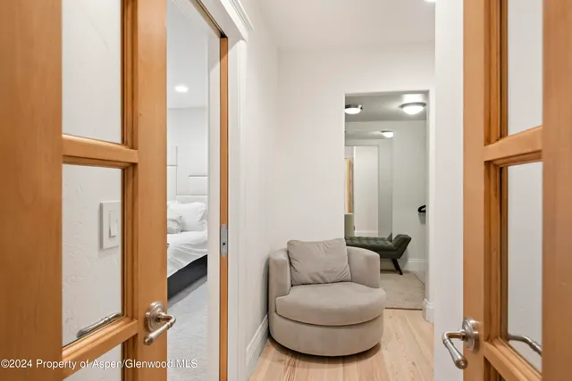 a living room with furniture and a mirror