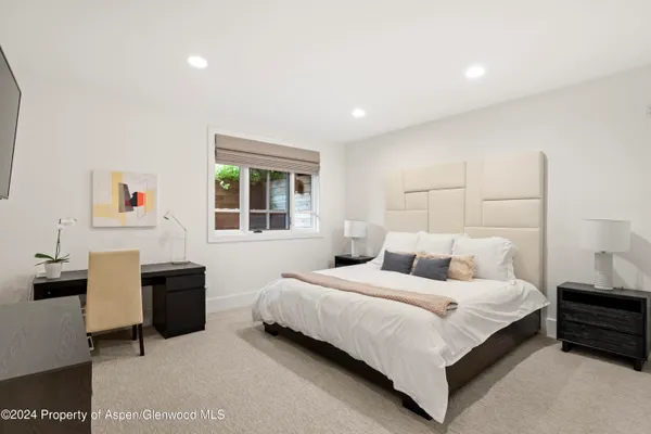 a bedroom with a bed and a desk