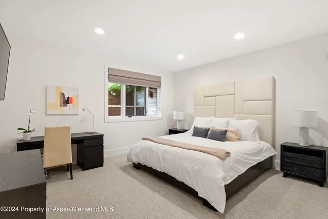 a bedroom with a bed and a desk