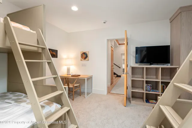 a view of a livingroom with furniture and a flat screen tv