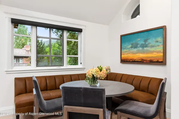 a dining room with furniture and a large window