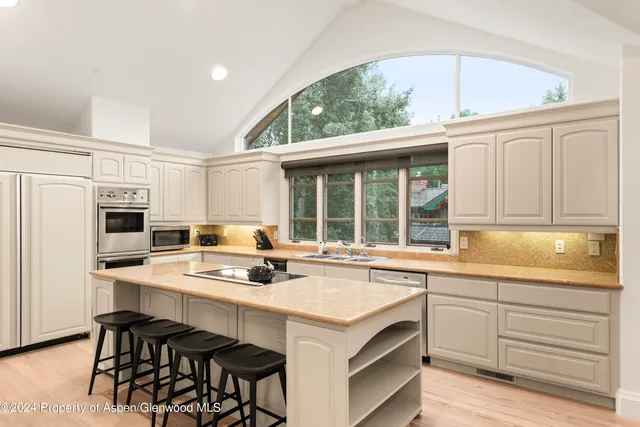 a kitchen with a stove a sink and a refrigerator