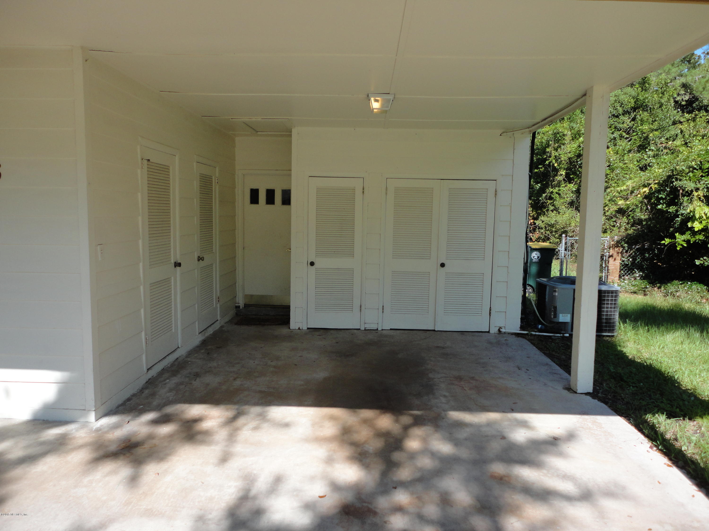 776 Acapulco Road Jacksonville, FL 32216 - Photo 21 of 22 car port with storage closets