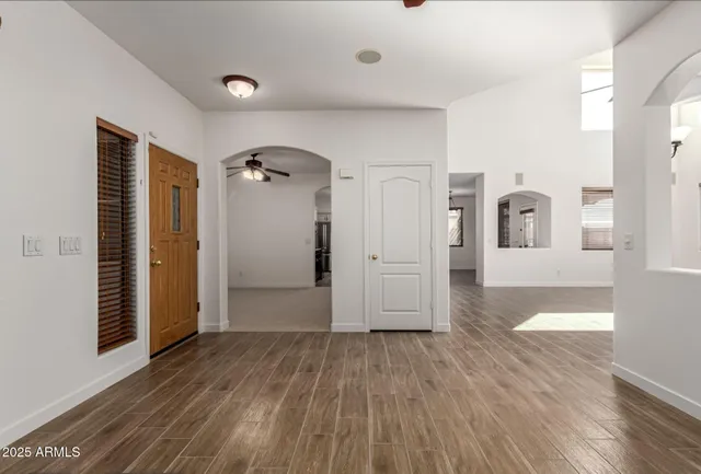 a view of entryway and hall with wooden floor