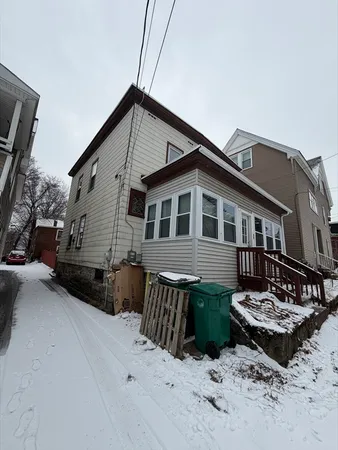 a view of a house with a yard and sitting area