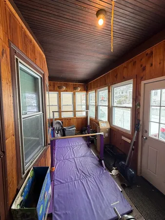 a living room with furniture large windows wooden floor and furniture