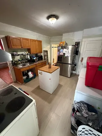 a kitchen with a sink and refrigerator