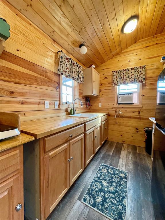 214 Cedar Creek Park Road Whitney, TX 76692 - Photo 17 of 32 a kitchen with a sink and wooden cabinets