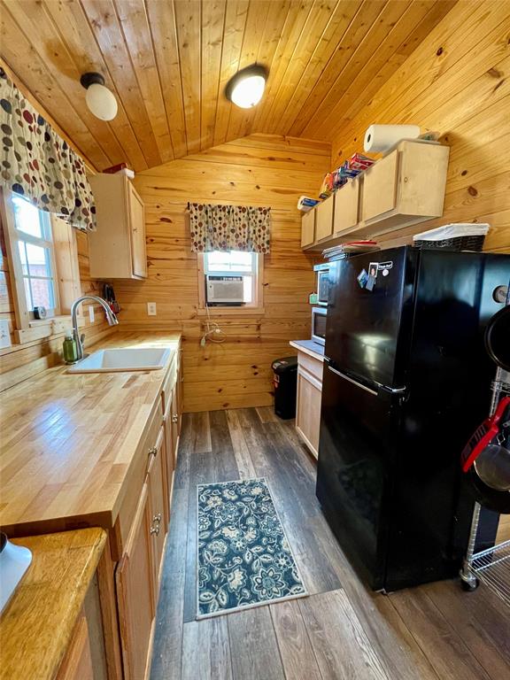 214 Cedar Creek Park Road Whitney, TX 76692 - Photo 18 of 32 a kitchen with stainless steel appliances wooden floor sink and wooden cabinets