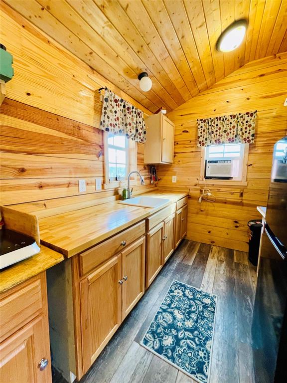 214 Cedar Creek Park Road Whitney, TX 76692 - Photo 19 of 32 a kitchen with a stove a sink and wooden floor